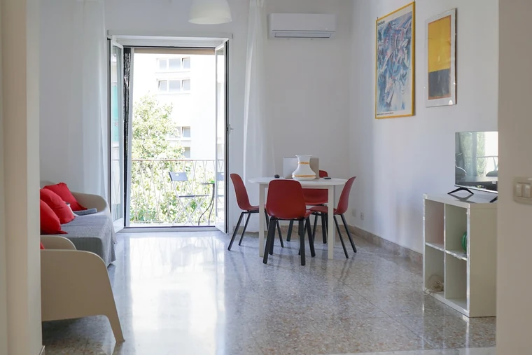 Casa Sanfelice, Roma: la zona pranzo con il tavolo tondo e le sedie rosse